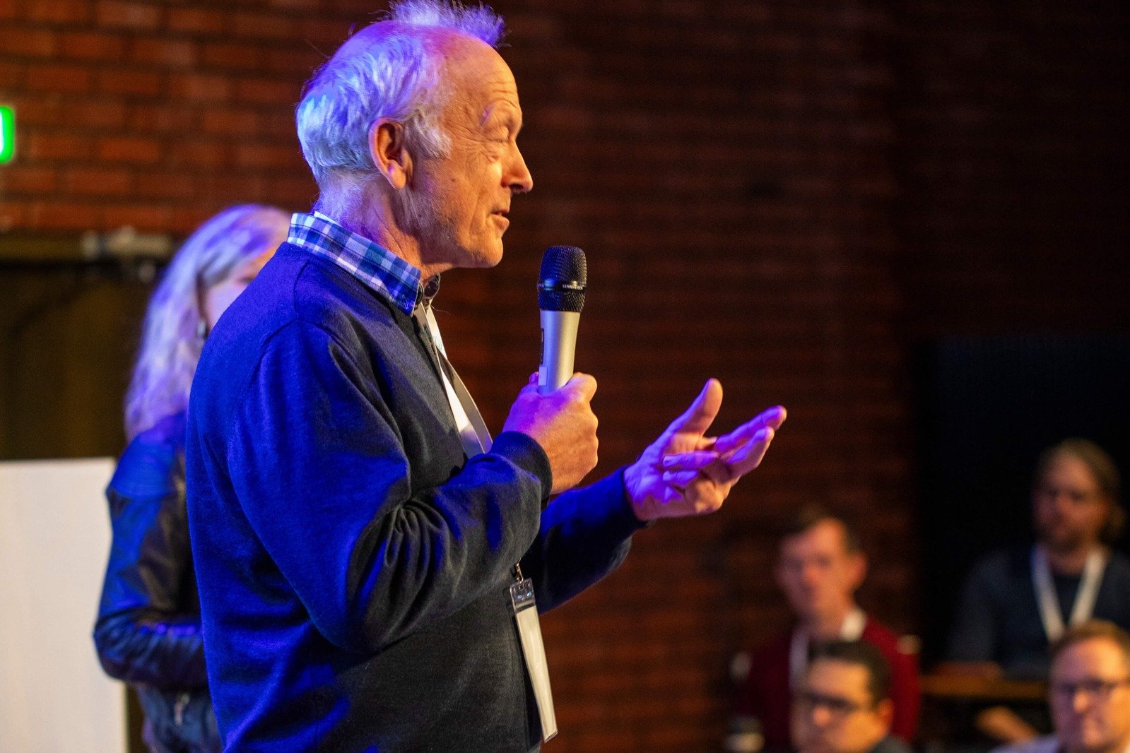 Professor Jørn Braa speaking into a microphone at the DHIS2 Annual Conference.