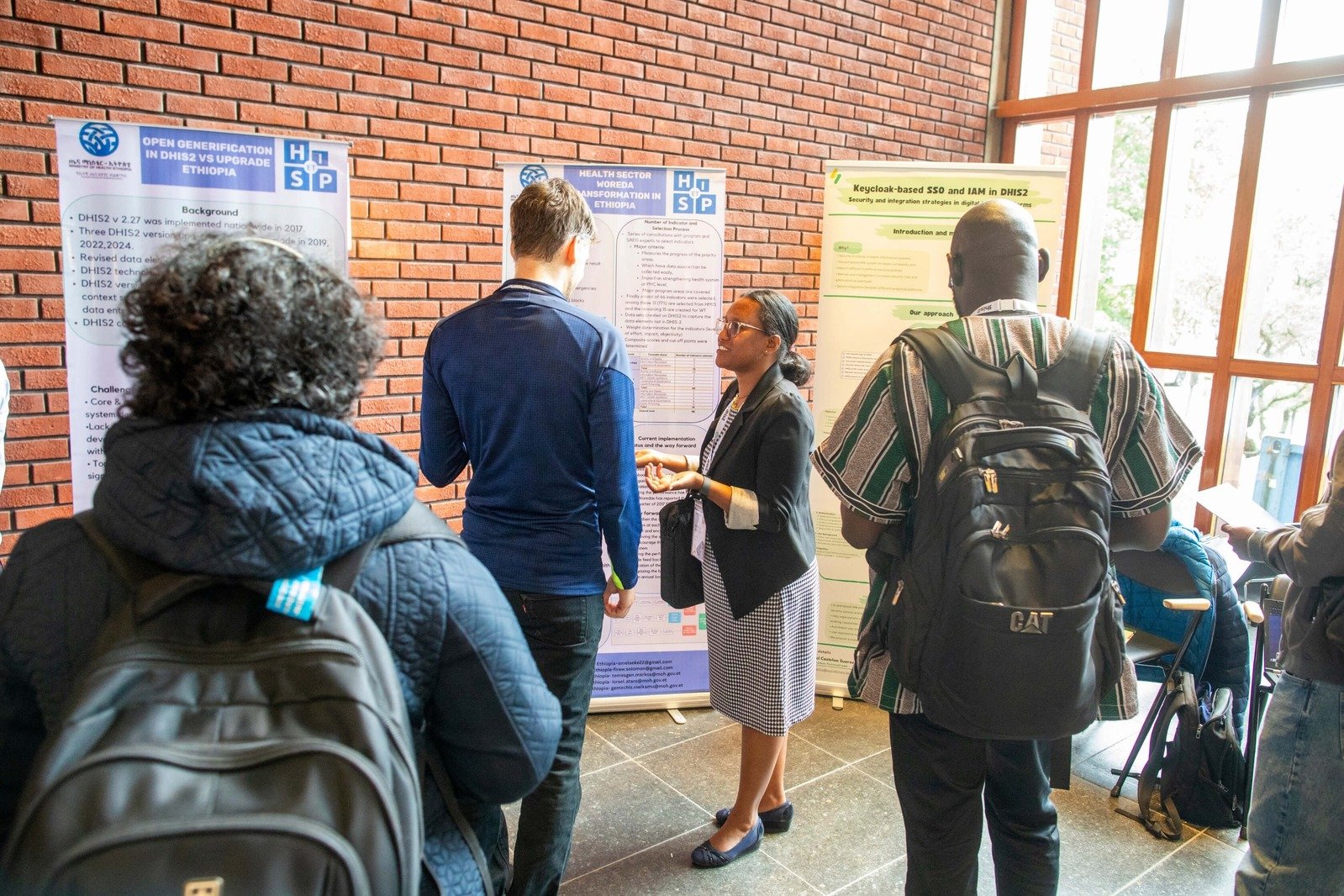 Attendees networking during a poster session at the DHIS2 Annual Conference.